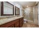 Bathroom featuring dual sinks, granite counters and glass shower enclosure at 10632 Star Thistle Ct, Highlands Ranch, CO 80126
