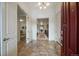 Inviting foyer with tile flooring, an open view to the upper level, and a classic red door at 10632 Star Thistle Ct, Highlands Ranch, CO 80126