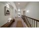 Hallway features a bench, decorative rug, stair rail, and an open view to other rooms at 10632 Star Thistle Ct, Highlands Ranch, CO 80126