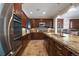 A well-appointed kitchen features an island, stainless steel appliances, and custom cabinetry at 10632 Star Thistle Ct, Highlands Ranch, CO 80126