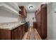Functional laundry room with wood floors and granite countertops at 10632 Star Thistle Ct, Highlands Ranch, CO 80126