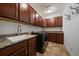 Laundry room features granite countertop, sink, and dark wood cabinets at 10632 Star Thistle Ct, Highlands Ranch, CO 80126