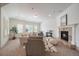 Spacious living room with neutral tones, shuttered windows, and a stone fireplace at 10632 Star Thistle Ct, Highlands Ranch, CO 80126