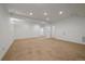 Large carpeted living room with recessed lighting and white walls at 10632 Star Thistle Ct, Highlands Ranch, CO 80126