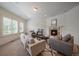 Bright living room with neutral tones, shuttered windows, and a stone fireplace at 10632 Star Thistle Ct, Highlands Ranch, CO 80126