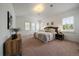 Tranquil main bedroom with plush carpeting, neutral colors, and bright, shuttered windows at 10632 Star Thistle Ct, Highlands Ranch, CO 80126