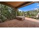Covered patio with hot tub and views of trees and blue sky at 10632 Star Thistle Ct, Highlands Ranch, CO 80126