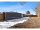 Large backyard with partially snow-covered ground at 6645 E 58Th Ave, Commerce City, CO 80022