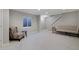 Finished basement area with neutral carpet, natural light, and seating for a cozy living space at 690 W Jamison Cir, Littleton, CO 80120