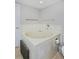 Bright bathroom featuring a tiled corner jacuzzi bathtub and white fixtures for a clean feel at 690 W Jamison Cir, Littleton, CO 80120