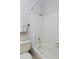 Clean bathroom with a shower-tub combo, white tile, and grab bar at 690 W Jamison Cir, Littleton, CO 80120