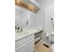 Clean and bright bathroom with a large mirror, white vanity, and good storage space at 690 W Jamison Cir, Littleton, CO 80120