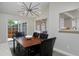 Bright dining room features modern chandelier and a sliding glass door to the outdoor area at 690 W Jamison Cir, Littleton, CO 80120