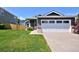 Gray single-Gathering home with a two-car garage, complemented by a lush lawn and inviting curb appeal at 690 W Jamison Cir, Littleton, CO 80120
