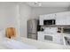 Efficient kitchen with white cabinets and stainless steel appliances providing a functional and stylish cooking space at 690 W Jamison Cir, Littleton, CO 80120