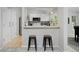 Bright kitchen area featuring white cabinetry and stainless steel appliances, perfect for casual dining at 690 W Jamison Cir, Littleton, CO 80120