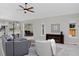 Open-concept living room with neutral paint, a ceiling fan, and direct view into the kitchen and dining areas at 690 W Jamison Cir, Littleton, CO 80120