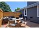 Cozy outdoor brick patio perfect for entertaining, featuring patio furniture and a grill at 690 W Jamison Cir, Littleton, CO 80120