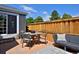 Brick patio featuring outdoor seating and privacy fence, perfect for relaxing and entertaining at 690 W Jamison Cir, Littleton, CO 80120