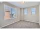 Bright bedroom with three windows and neutral carpeting at 9660 Browns Peak Cir, Littleton, CO 80125