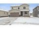 Two-story house with attached garage and snow-covered front yard at 1382 Rock Cliff Ave, Erie, CO 80516