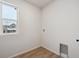 Bright laundry room with vinyl flooring and window at 1382 Rock Cliff Ave, Erie, CO 80516