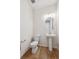 Modern powder room with pedestal sink and wood-look flooring at 1382 Rock Cliff Ave, Erie, CO 80516