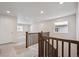 Upstairs hallway with wood railing overlooking the main floor at 1382 Rock Cliff Ave, Erie, CO 80516