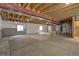 Spacious unfinished basement with exposed ceiling and concrete floor; great for storage or customization at 7470 Blue Water Ln, Castle Rock, CO 80108