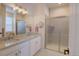 Modern bathroom with double sinks, granite countertops, and a glass-enclosed shower at 7470 Blue Water Ln, Castle Rock, CO 80108