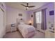 A bedroom with a ceiling fan, a light color palette, a comfortable bed, and large windows at 7470 Blue Water Ln, Castle Rock, CO 80108