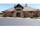 Exterior shot of the Cobblestone Ranch community center showcasing stone architecture at 7470 Blue Water Ln, Castle Rock, CO 80108
