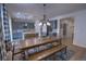 Dining area next to the kitchen, featuring a long wooden table and views into the living room at 7470 Blue Water Ln, Castle Rock, CO 80108