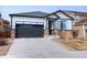Charming single-Gathering home with stone accents, dark trim, and a two-car garage at 7470 Blue Water Ln, Castle Rock, CO 80108