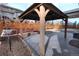 View inside a backyard gazebo, showcasing stone landscaping and a wood privacy fence at 7470 Blue Water Ln, Castle Rock, CO 80108