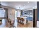 Open kitchen featuring blue cabinets, an island with seating, and modern pendant lighting at 7470 Blue Water Ln, Castle Rock, CO 80108