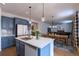 Spacious kitchen island with a sink and dining area in an open-concept layout at 7470 Blue Water Ln, Castle Rock, CO 80108