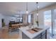 Bright kitchen with modern features and an adjacent dining area overlooking a backyard at 7470 Blue Water Ln, Castle Rock, CO 80108