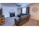 Cozy living room with a fireplace and comfortable leather furniture at 7470 Blue Water Ln, Castle Rock, CO 80108