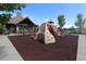 Community playground with modern equipment and a clubhouse in the background at 7470 Blue Water Ln, Castle Rock, CO 80108
