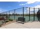 Well-maintained community tennis courts with a bench and a secure fence at 7470 Blue Water Ln, Castle Rock, CO 80108