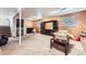 Large basement with wood paneled walls, neutral carpet, and ample space for various activities at 11797 Keough Dr, Northglenn, CO 80233
