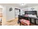 Bedroom with hardwood floors, closet space, and neutral walls at 11797 Keough Dr, Northglenn, CO 80233