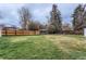 Large grassy backyard enclosed by a wood fence, offering ample space for outdoor activities and privacy at 2965 S Birch St, Denver, CO 80222