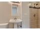 Bathroom featuring pedestal sink and tiled shower at 2965 S Birch St, Denver, CO 80222