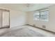 Bright bedroom with large window and neutral carpet, offering a serene and comfortable space at 2965 S Birch St, Denver, CO 80222