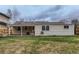 Exterior of home with covered patio, backyard, and tan siding under a cloudy sky at 2965 S Birch St, Denver, CO 80222