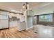 Bright, open kitchen features white cabinets, hardwood floors, stainless steel appliances, and natural light from a skylight at 2965 S Birch St, Denver, CO 80222