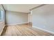Open living room with hardwood floors, neutral paint, and large window providing natural light and bright, airy atmosphere at 2965 S Birch St, Denver, CO 80222