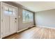 Bright, open living room with a beautiful hardwood floor, large window, and freshly painted walls at 2965 S Birch St, Denver, CO 80222